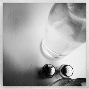 Bottle of Water with Salt and Pepper Shakers